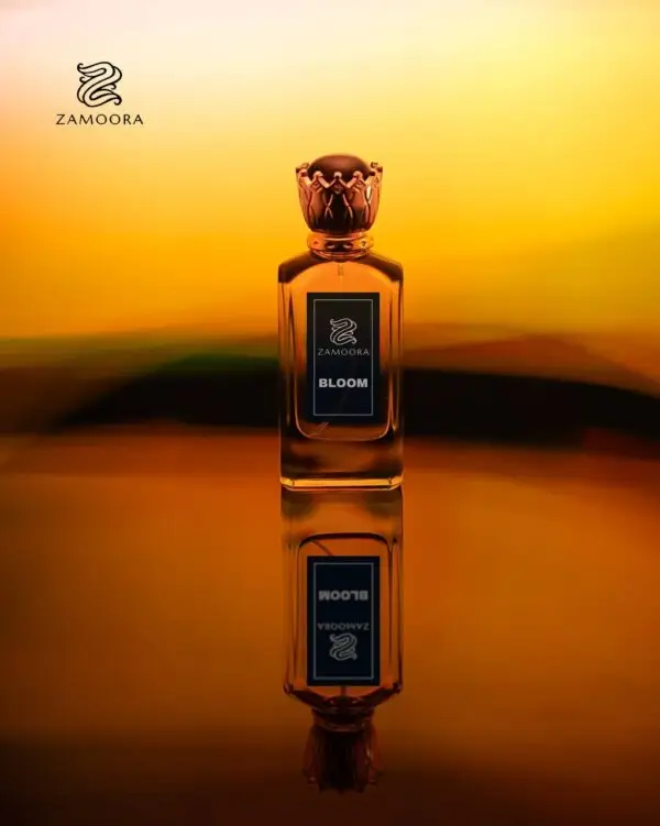 Zamoora Bloom perfume bottle for men floating underwater, surrounded by bubbles, with top notes of bergamot, blood orange and saffron, heart notes of damask rose, jasmine sambac, cinnamon and black tea, and base notes of amber, oud, sandalwood, musk and patchouli