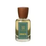 Zamoora Emberlyn perfume bottle for women displayed on gemstones with a teal background, featuring top notes of bergamot, blood orange and pink pepper, heart notes of jasmine blossom, honey and peony, and base notes of amberwood, vanilla and white musk