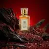 Zamoora Royal Oud men’s perfume bottle placed in a dark, earthy setting with woody textures, showing top notes of grapefruit, bergamot, lavender, saffron, cardamom, and spices, middle notes of tobacco, agarwood, cedarwood, jasmine and cashmeran, and deep base notes of leather, oud, sandalwood, vetiver, musk, vanilla and amber