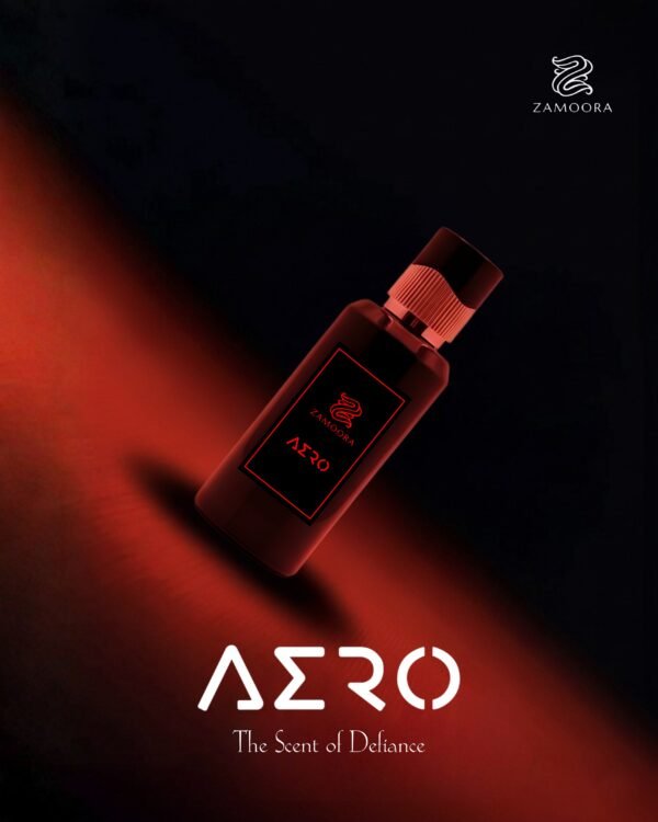 Zamoora Aero men’s perfume bottle displayed on a light wooden stand against a bold red background, featuring top notes of watermelon, red fruits, lavender and Sicilian orange, heart notes of lily of the valley, lotus and jasmine, and base notes of sandalwood, white musk and ambroxan.